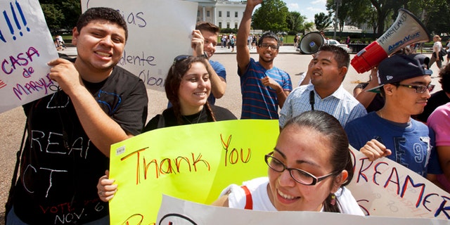 FILE - In this June 15, 2012 file photo, young demonstrators participate in a rally in support of President Barack Obama after the president announced that the U.S. government will stop deporting and begin granting work permits to younger illegal immigrants who came to the U.S. as children and have since led law-abiding lives. Young Hispanic and Asian-Americans who are immigrants themselves or have a parent who is are more likely to be liberal in their views on politics and immigration than those with families who have been in United States longer, a new GenForward poll shows. (AP Photo/Jacquelyn Martin, File)