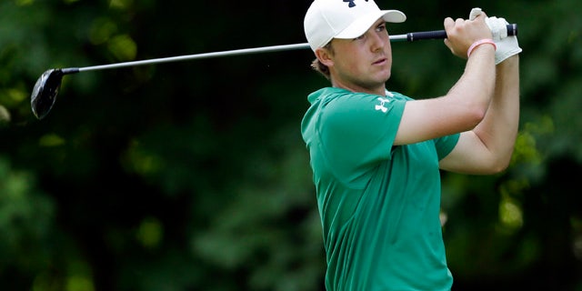July 14, 2013: Jordan Spieth hits off the 17th green during the final round of the John Deere Classic golf tournament.