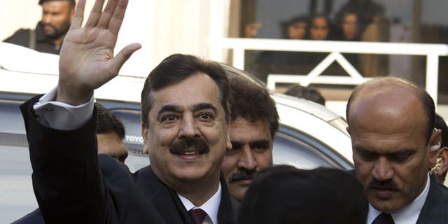 January 19, 2012: Pakistani Prime Minister Yousuf Raza Gilani waves upon his arrival at the Supreme Court in Islamabad.