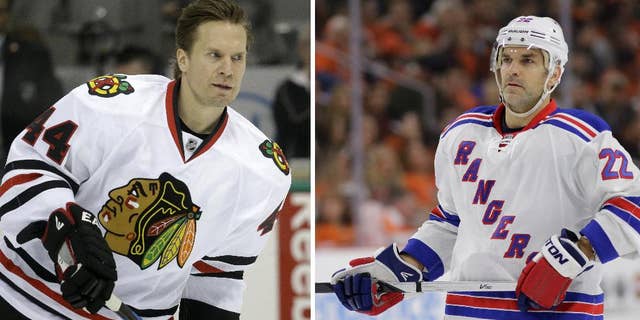 ADVANCE FOR WEEKEND EDITIONS, MAY 15-17 - FILE - At left, in a March 21, 2015, file photo, Chicago Blackhawks defenseman Kimmo Timonen (44) skates during warms ups before an NHL hockey game in Dallas. At right, in a Feb. 28, 2015, file photo, New York Rangers' Dan Boyle skates during an NHL hockey game against the Philadelphia Flyers in Philadelphia. Eight of Anaheim's best players are 24 or younger, and Tampa Bay has the youngest remaining player in the NHL playoffs in 20-year-old winger Jonathan Drouin. The Blackhawks counter with 20-year-old forward Teuvo Teravainen, and the oldest remaining player in 40-year-old defenseman Kimmo Timonen. The Rangers have seasoned veterans Martin St. Louis and Dan Boyle. (AP Photo/File)