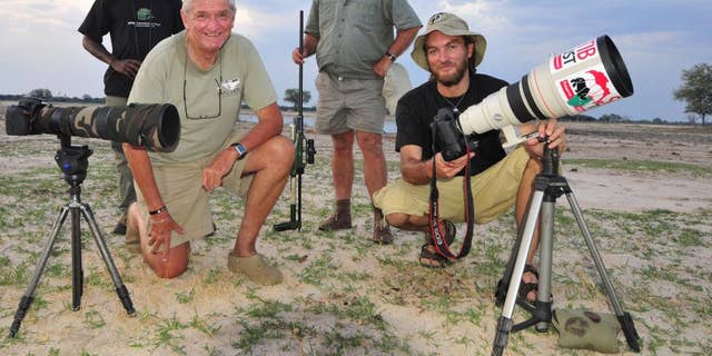 In this photo taken Nov. 9,  2014 photographer Brent Stapelkamp, front right,  with colleagues in the Hwange National Park, Zimbabwe. Stapelkamp, a lion researcher and part of a team that had tracked and studied Cecil the lion for nine years darted him and attached a collar last year. He was probably the last person to get up close before Minnesota dentist Walter Palmer killed the now-famous lion with the bushy black mane and, aided by a Zimbabwean professional hunter, cut off its head and skin for trophies.  (AP Photo/Derek Whalley)