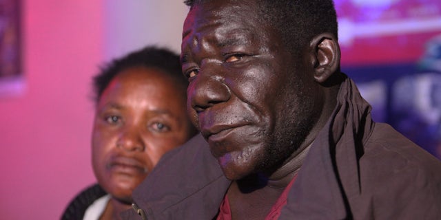 William Masvinhu, right, winner of  the Mr Ugly competition poses for a photo with his wife Alice at a local club in Harare, Tuesday, May, 29, 2012. The competition which is in its second year was won by William Masvinhu who walked away with US$100 in cash and one night accommodation voucher at a 3 star hotel while  Freddy Mwanda came second walking away with US$50.  (AP Photo/Tsvangirayi Mukwazhi)