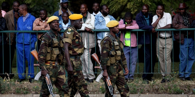 July 14: Members of the Zimbabwe National Army take up positions following the arrival of President Robert Mugabe, for the presentation of the mid term monetary review in Harare. (AP)