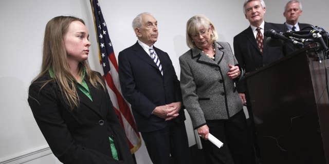 Kelly O'Brien, fiance of Congressional staffer Gabe Zimmerman who was killed in the shooting rampage in Tucson, Ariz., left, attends a news conference on Capitol Hill in Washington, Tuesday, April 12, 2011, to endorse legislation to ban large-capacity ammunition magazines. From left are, O'Brien, Sen. Frank Lautenberg, D-N.J., Rep. Carolyn McCarthy, D-N.Y., Paul Helmke, president of the Brady Campaign, and Ross Zimmerman, father of shooting victim Gabe Zimmerman. (AP Photo/J. Scott Applewhite)