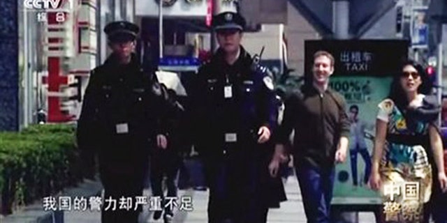 In this image taken from undated CCTV video, Facebook founder Mark Zuckerberg and his now-wife, Priscilla Chan, appear in a Chinese TV documentary about the countrys police force. The footage shows the couple wearing the same clothes they were photographed in during a March 27, 2012 visit to Shanghai.