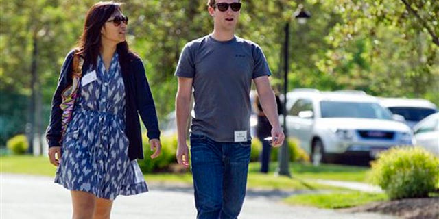 In this July 9, 2011, file photo, Mark Zuckerberg, president and CEO of Facebook, walks with Priscilla Chan during the 2011 Allen and Co. Sun Valley Conference, in Sun Valley, Idaho. Zuckerberg and his wife, Chan, were the most generous American philanthropists in 2013, The Chronicle of Philanthropy reported, Monday, Feb. 10, 2014, with a donation of 18 million Facebook shares, valued at more than $970 million, given to a Silicon Valley nonprofit in December. (AP)