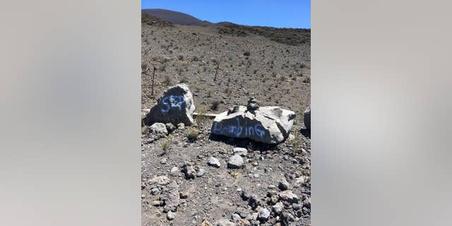 This undated photo provided by the Hawaii Department of Land and Natural Resources shows graffiti within a protected area on one of Hawaii's most revered mountains in the Mauna Kea Ice Age Reserve. The department said the graffiti was found on April 28, 2017, and authorities are asking for the public's help in finding out who painted the graffiti. (Hawaii Department of Land and Natural Resources via AP)