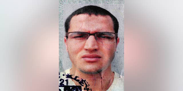 The photo issued by German federal police on Wednesday, Dec. 21, 2016 shows 24-year-old Tunisian Anis Amri on a photo that was used on the documents found in the truck. He is suspected of being involved in the fatal attack on the Christmas market in Berlin on Dec. 19, 2016. German authorities are offering a reward of up to 100,000 euros (US$ 105,000) for the arrest of the Tunisian. (German police via AP)