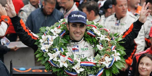 FILE - In this May 27, 2007, file photo, Dario Franchitti, of Scotland, gestures after his win in the Indianapolis 500 auto race at Indianapolis Motor Speedway in Indianapolis, Ind. At lower right is his wife, actress Ashley Judd. (AP Photo/Darron Cummings, File)