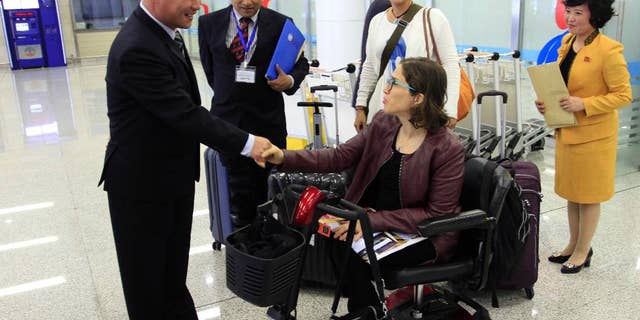FILE - In this May 2, 2017, file photo, Catalina Devandas Aguilar, U.N. Special Rapporteur on the Rights of Persons with Disabilities, shakes hands with Kim Mun Chol, left, chairman of the Central Committee of the Korean Federation for the Protection of the Disabled, at Pyongyang's international airport, in Pyongyang, North Korea. Devandas Aguilar is the first U.N. Human Rights Council (OHCHR) official to visit North Korea. (AP Photo/Jon Chol Jin, File)