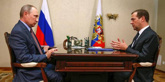 Russian President Vladimir Putin, left, and Prime Minister Dmitry Medvedev meet in Belbek in Crimea, Friday, Aug. 19, 2016. 