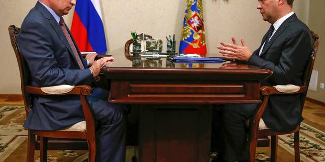 Russian President Vladimir Putin, left, and Prime Minister Dmitry Medvedev meet in Belbek in Crimea, Friday, Aug. 19, 2016.