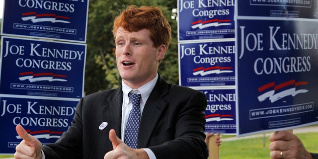 Joseph Kennedy III, son of former U.S. Rep. Joseph P. Kennedy II and grandson of the late Robert F. Kennedy gestures while visiting voters outside a polling station at a school in Needham, Mass., Thursday, Sept. 6, 2012. The 31-year-old Kennedy is vying for the House seat being vacated by Democratic U.S. Rep. Barney Frank. (AP Photo/Steven Senne)
