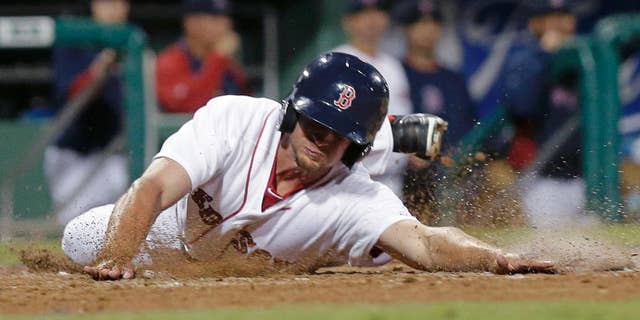 Boston Red Sox Jonathan Roof reaches home on an RBI double by Mike McCoy in the eighth inning of an exhibition baseball game against the Minnesota Twins in Fort Myers, Fla., Thursday, March 27, 2014. The Red Sox won 4-1. (AP Photo/Gerald Herbert)