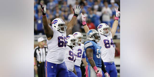 Buffalo Bills tackle Seantrel Henderson (66) celebrates as he watches a 58 -yard game-winning field goal in the fourth quarter of an NFL football game against the Detroit Lions Sunday, Oct. 5, 2014, in Detroit. The Bills defeated the Lions 17-14.(AP Photo/Duane Burleson)