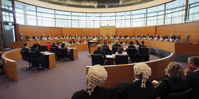 FILE - In this Aug. 10, 2015 file picture the UN mandated tribunal and the delegations of India, left, and Italy, right, are pictured during the first public hearing on the request for provisional measures in the “Enrica Lexie” incident at the International Tribunal for the Law of the Sea in Hamburg, northern Germany. The tribunal has ordered India to put on hold legal proceedings against two Italian marines accused of killing two Indian fishermen in 2012. The tribunal on Monday Aug. 24, 2015 ordered both sides to suspend “all court proceedings” and refrain from initiating new ones pending an arbitration decision. (AP Photo/Focke Strangmann,file)