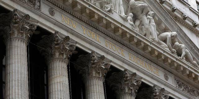FILE - This Thursday, Oct. 2, 2014, file photo, shows the facade of the New York Stock Exchange. Stock markets turned lower on Wednesday, Feb. 4, 2015, despite upbeat economic data in Europe, while the price of oil's four-day rebound ran out of steam. (AP Photo/Richard Drew, File)