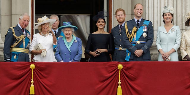 Members of the royal family gather on the balcony of Buckingham Palace, with from left, Prince Charles, Camilla the Duchess of Cornwall, Prince Andrew, Queen Elizabeth II, Meghan the Duchess of Sussex, Prince Harry, Prince William and Kate the Duchess of Cambridge, as they watch a flypast of Royal Air Force aircraft pass over Buckingham Palace.