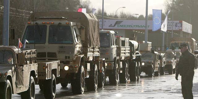 U.S. Army vehicles cross the Polish border in Olszyna, Poland, Thursday.