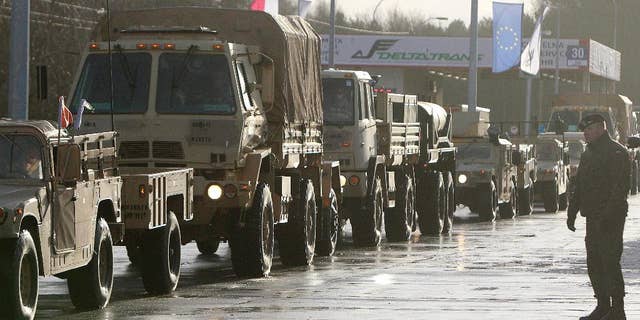 U.S. Army vehicles cross the Polish border in Olszyna, Poland, Thursday.