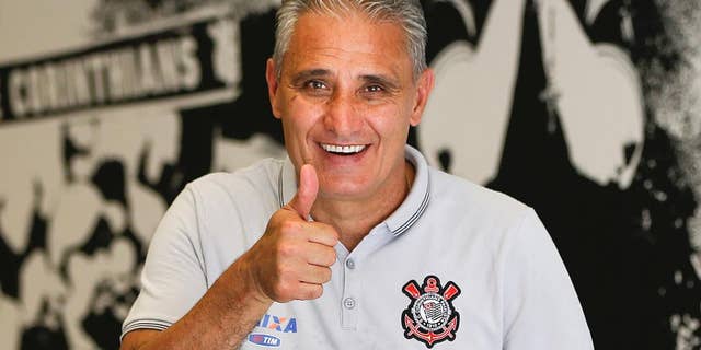 FILE - In this Dec. 5, 2015 file photo, Corinthians soccer coach Adenor Leonardo Bacchi, known as Tite, flashes a thumbs up as he poses after a team training session at the Itaquerao stadium, in Sao Paulo, Brazil. On Wednesday, June 15, 2016, the president of the Corinthians football club announced that Tite, has been named the new coach of Brazil's national team. (AP Photo/Andre Penner, File)