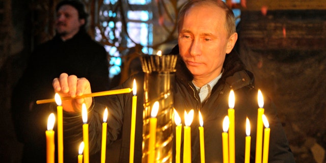 Jan. 30: Russian Prime Minister Vladimir Putin lights a cande as he visits the Tikhvin Assumption Monastery in the town of Tikhvin, about 106 miles east of St. Petersburg.