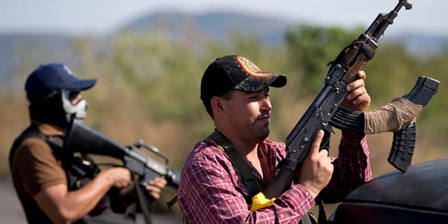 Armed men from the Self-Defense Council of Michoacán at the entrance of Antúnez, Mexico, Jan. 14, 2014.