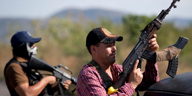 Armed men from the Self-Defense Council of Michoacán at the entrance of Antúnez, Mexico, Jan. 14, 2014.