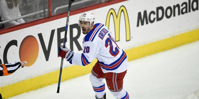 New York Rangers defenseman Dan Girardi (5) battles for the puck against Washington Capitals left wing Alex Ovechkin (8), from Russia, during the first period of Game 6 in the second round of the NHL Stanley Cup hockey playoffs, Sunday, May 10, 2015, in Washington. (AP Photo/Nick Wass)