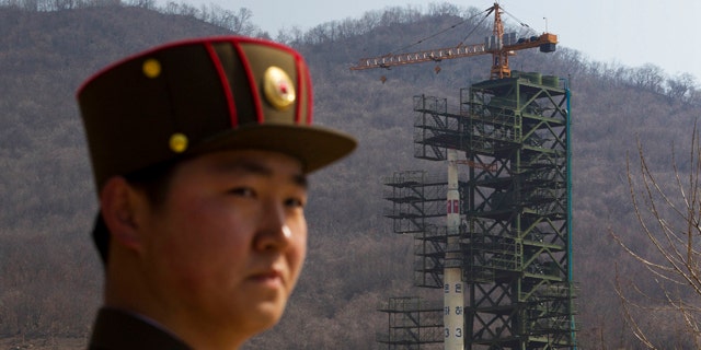 April 8: A North Korean soldier stands in front of the country's Unha-3 rocket, slated for liftoff between April 12-16, at a launching site in Tongchang-ri, North Korea.