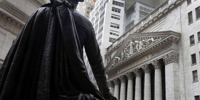 FILE - In this Oct. 2, 2014, file photo, the statue of George Washington on the steps of Federal Hall faces the facade of the New York Stock Exchange. U.S. employers added a vigorous 257,000 jobs in January, and wages jumped by the most in six years, evidence that the job market is accelerating closer to full health. The surprisingly robust report the government issued Friday, Feb. 6, 2015 also showed that hiring was far stronger in November and December than it had previously estimated. .(AP Photo/Richard Drew, File)
