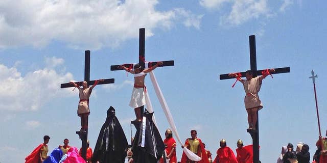 Filipino penitents on wooden crosses take part in a reenactment during Good Friday rituals on Friday, April 14, 2017 at Cutud, Pampanga province, northern Philippines. They were remembering Jesus Christ's suffering and death. (AP Photo/Vicente Gonzales)