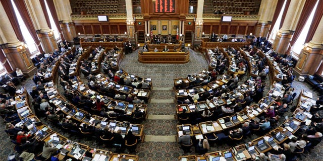 FILE: State representatives work in the Iowa House on the opening day of the Iowa Legislature at the Statehouse in Des Moines, Iowa.