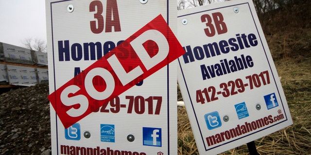In this Monday, Jan. 13, 2014, photo, a sold sign is placed on a homesite in the Grace Manor townhouse development in Robinson Township, Pa. Freddie Mac, the mortgage company, releases weekly mortgage rates on Thursday, Jan. 23, 2014. (AP Photo/Gene J. Puskar)
