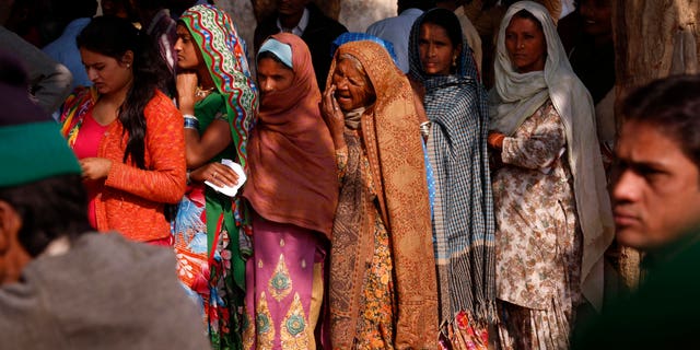 People wait in queues to cast their votes in New Delhi, India, Wednesday, Dec. 4, 2013. Nearly 12 million residents were expected to vote to select the assembly, in a poll that analysts say is expected to show a trend for the three parties heading into next year's national elections in the world's biggest democracy. (AP Photo/Saurabh Das)