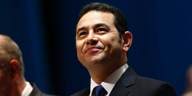 FILE - In this Jan. 14, 2016, file photo, Guatemala's President Jimmy Morales arrives for his inauguration ceremony at the National Theater in Guatemala City. The son and brother of Morales have made statements to prosecutors investigating the misappropriation of funds, on Tuesday, Sept. 13. President Morales says both made their statement in person at the Attorney General's Office. (AP Photo/Moises Castillo, File)