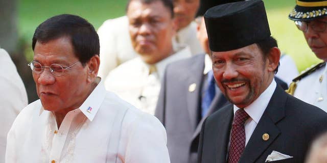 Sultan Hassanal Bolkiah, right, of Brunei and Philippine President Rodrigo Duterte, chat as they walk for their bilateral meeting following welcoming ceremony for the Sultan Thursday, April 27, 2017 at Malacanang Palace in Manila, Philippines. Bolkiah arrived Wednesday for a state visit and to attend the annual ASEAN Leaders' Summit which the Philippines is hosting this weekend.(AP Photo/Bullit Marquez)