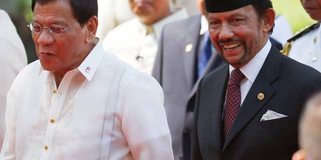 Sultan Hassanal Bolkiah, right, of Brunei and Philippine President Rodrigo Duterte, chat as they walk for their bilateral meeting following welcoming ceremony for the Sultan Thursday, April 27, 2017 at Malacanang Palace in Manila, Philippines. Bolkiah arrived Wednesday for a state visit and to attend the annual ASEAN Leaders' Summit which the Philippines is hosting this weekend.(AP Photo/Bullit Marquez)