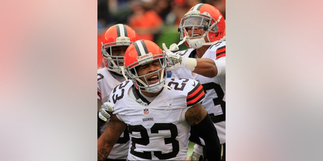 FILE - In this Nov. 17, 2013 file photo, Cleveland Browns cornerback Joe Haden (23) celebrates after scoring a touchdown on an interception in the first half of an NFL football game against the Cincinnati Bengals in Cincinnati. Haden, playing the best football of his life, credits his growth as a player to his four-game suspension last season and his maturity to getting married earlier this year. (AP Photo/Tom Uhlman)