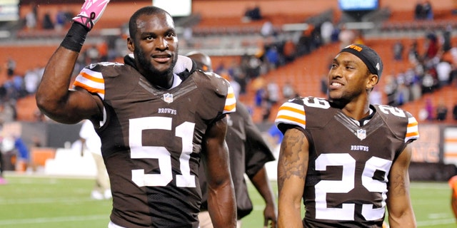 Cleveland Browns outside linebacker Barkevious Mingo (51) and cornerback Leon McFadden (29) celebrate after a 37-24 win over the Buffalo Bills in an NFL football game Thursday, Oct. 3, 2013, in Cleveland. (AP Photo/David Richard)