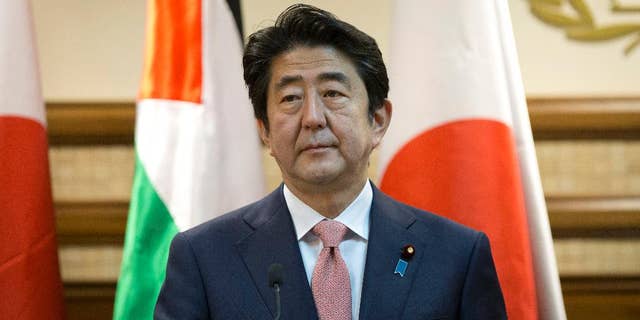 Japanese Prime Minister Shinzo Abe attends a joint press conference with Palestinian President Mahmoud Abbas at the Palestinian Authority headquarters, in the West Bank city of Ramallah, Tuesday, Jan. 20, 2015. An online video released Tuesday purported to show the Islamic State group threatening to kill two Japanese hostages unless they receive a $200 million ransom in the next 72 hours. (AP Photo/Nasser Nasser)