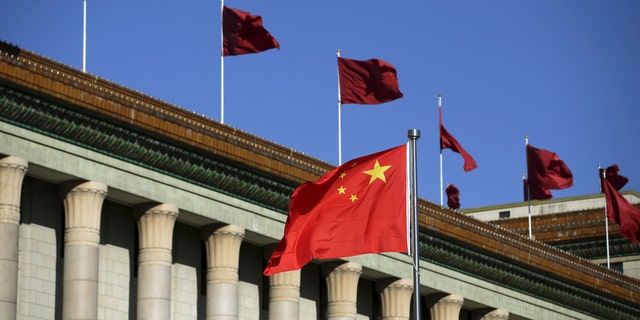 The Chinese flag waves in front of the Great Hall of the People in Beijing, China, 29 October 2015.