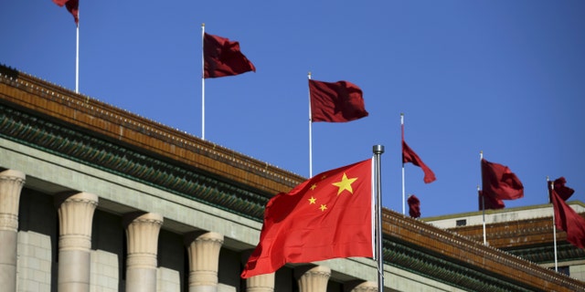 The Chinese flag waves in front of the Great Hall of the People in Beijing, China, Oct. 29, 2015.