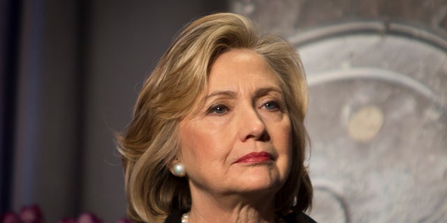 Hillary Clinton listens before delivering keynote remarks at the Global Alliance for Clean Cookstoves summit, Nov. 21, 2014 in New York.