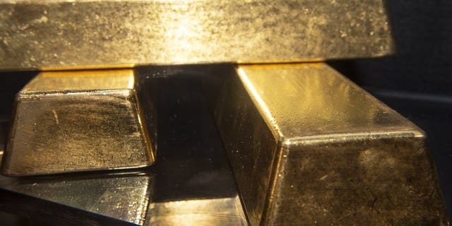 Three gold bullion bars with a combined value of more than $2 million on display at the Bureau of Engraving and Printing in Washington, on August 27, 2012