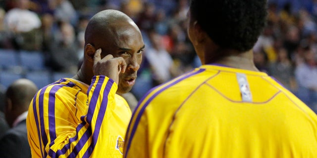 Los Angeles Lakers' Kobe Bryant, left, talks to Nick Young before an NBA preseason basketball game against the Denver Nuggets on Tuesday, Oct. 8, 2013, in Ontario, Calif. (AP Photo/Jae C. Hong)