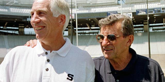 Jerry Sandusky, left, stands with Penn State football coach Joe Paterno.