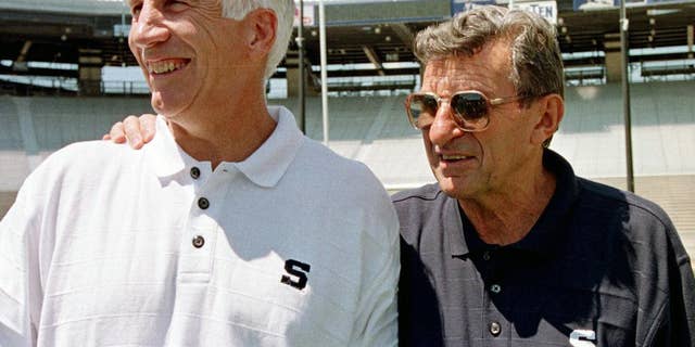Jerry Sandusky, left, stands with Penn State football coach Joe Paterno.
