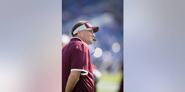 Mississippi State head coach Dan Mullen watches his team warm up before an NCAA college football game against Kentucky at Commonwealth Stadium in Lexington, Ky., Saturday, Oct. 25, 2014. (AP Photo/David Stephenson)