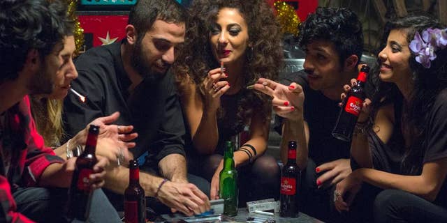 This undated handout photo provided by Deux Beaux Garcon Films shows a scene from the movie "In Between", the new award-winning film about Arab women battling their conservative society has touched off a real-life battle: the municipality of a major Arab city in Israel has called for a boycott of the film, and the film's director says she has received death threats for her unflinching portrayal of sex, drugs, parties, homosexuality and rape in her community. (Itay Gross, Deux Beaux Garcon Films via AP)